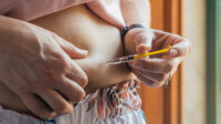 woman injecting heparin into stomach