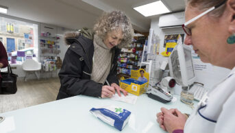 patient collecting prescription