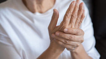 older woman holding wrist