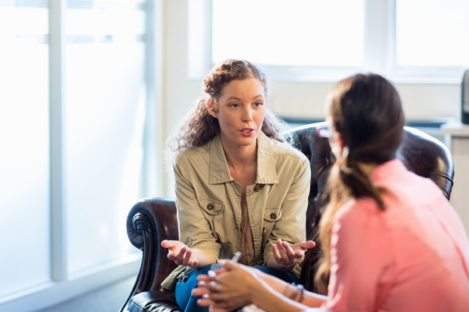 woman talking to another woman in therapy setting