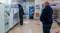 Customers at a pharmacy counter
