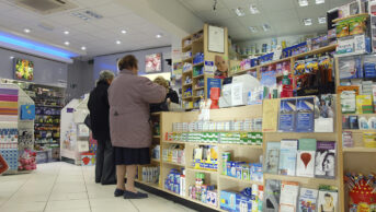 customers standing at pharmacy counter