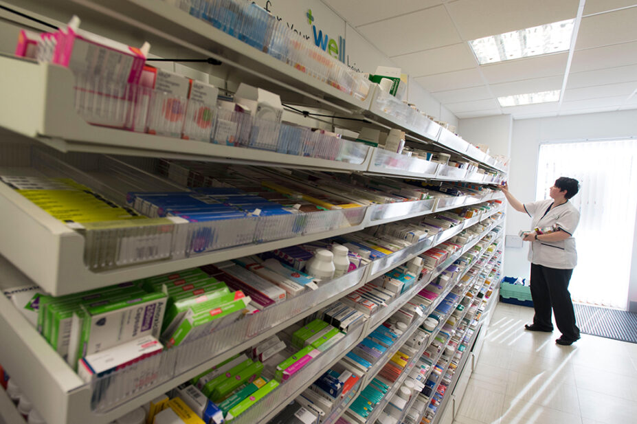 A female pharmacist at work in a pharmacy dispensary
