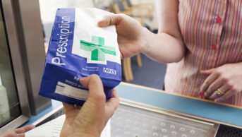 Prescription bag being handed to a to a patient at a hospital dispensary
