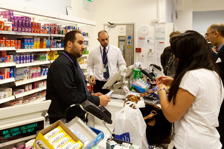 Queue of people at a pharmacy counter