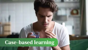 Hesitant man taking a tablet with a glass of water.