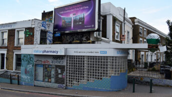 pharmacy on street with shutters down