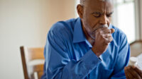 older man coughing