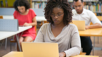 students on laptops sitting on individual desks