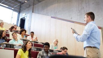 lecturer teaching students in auditorium