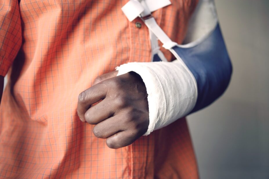 Photo of a man in a cast and sling for a broken arm