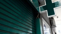 A pharmacy store with its shutters down