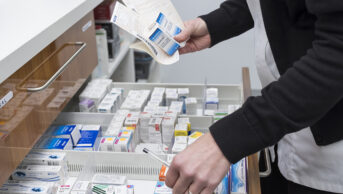 Pharmacy. Technician preparing prescriptions at a pharmacy.