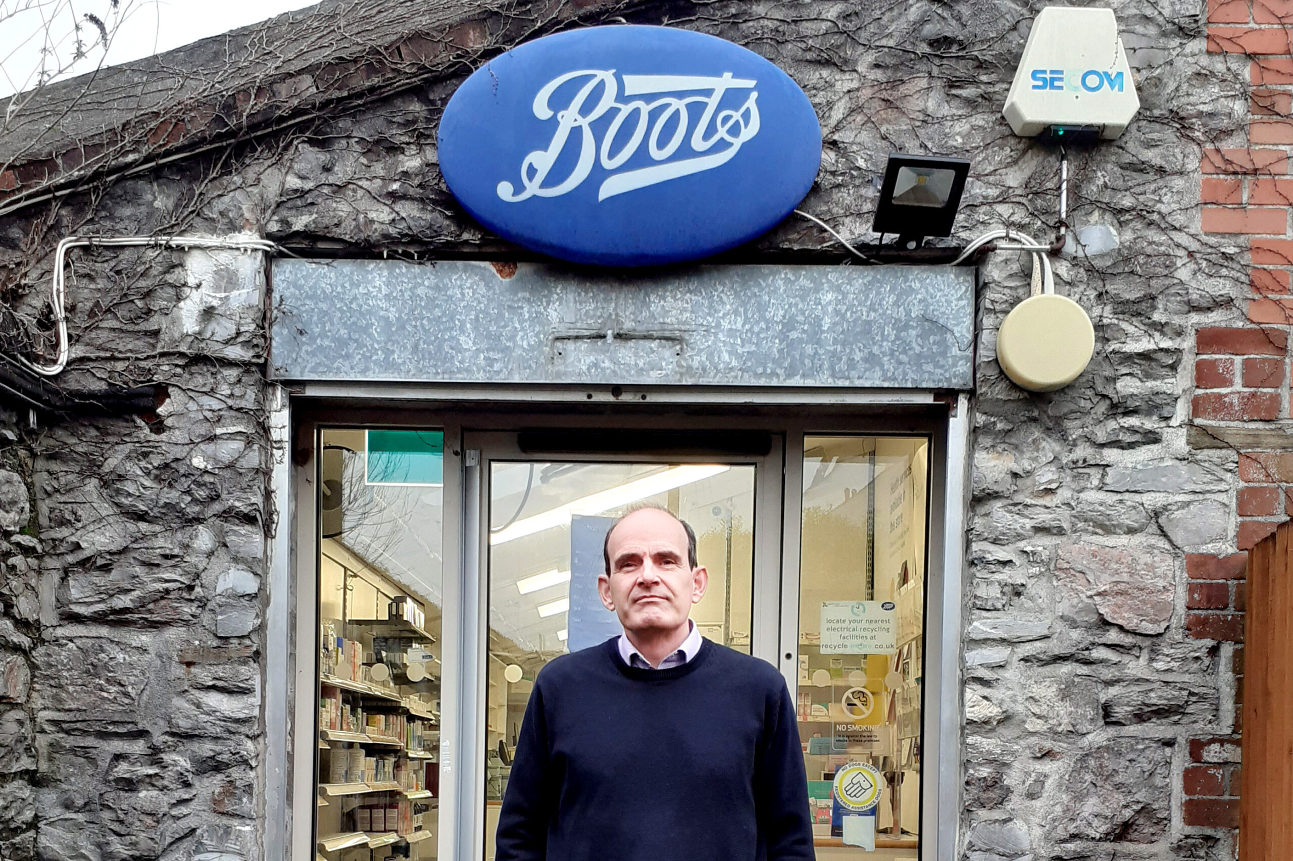 Photo of Andrew Potter in front of a Boots pharmacy
