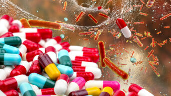 Photo illustration of a cascade of pills calling into a system, with antibiotic resistant bacteria untouched