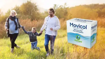 Photo of a family walking through an autumnal field, with a pregnant mother, child and father, and the new Movicol packaging on the right hand side of the image