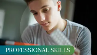 Young man looking at a packet of antidepressants, with the blister pack in one hand and the pack in the other