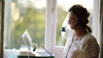 Woman using a nebuliser device
