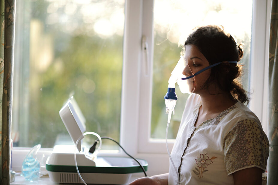 Woman using a nebuliser device