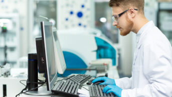 Researcher in laboratory working at a computer