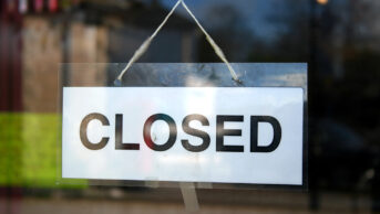 Closed sign in pharmacy window