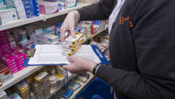Pharmacy technician preparing prescriptions at a pharmacy
