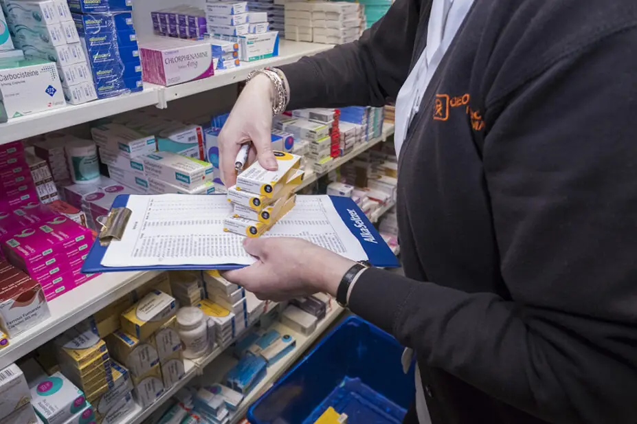 Pharmacy technician preparing prescriptions at a pharmacy