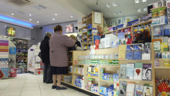two older women at pharmacy counter