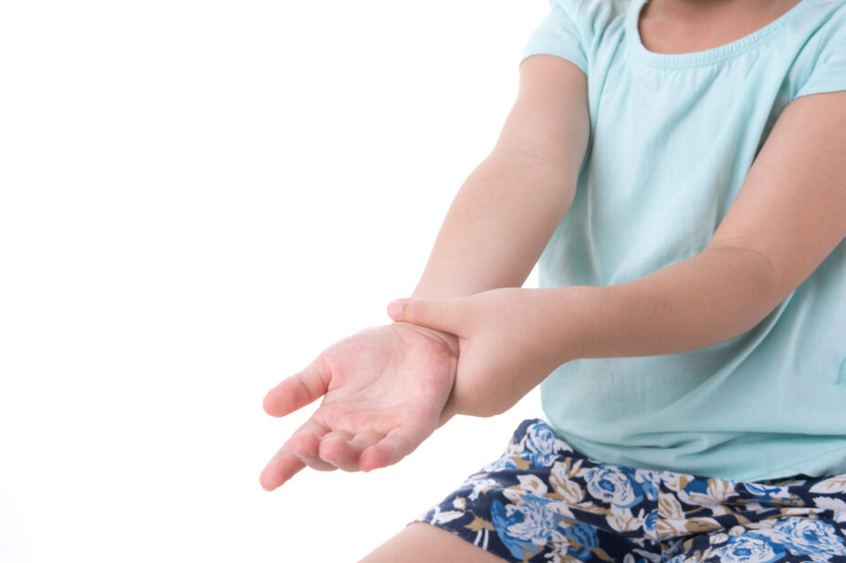 Photo of a child stretching an inflamed (highlighted in red) wrist