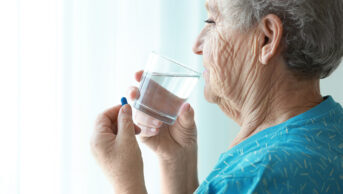 Older woman taking medicine