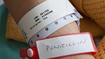 Patient in hospital with penicillin allergy warning information on wrist band