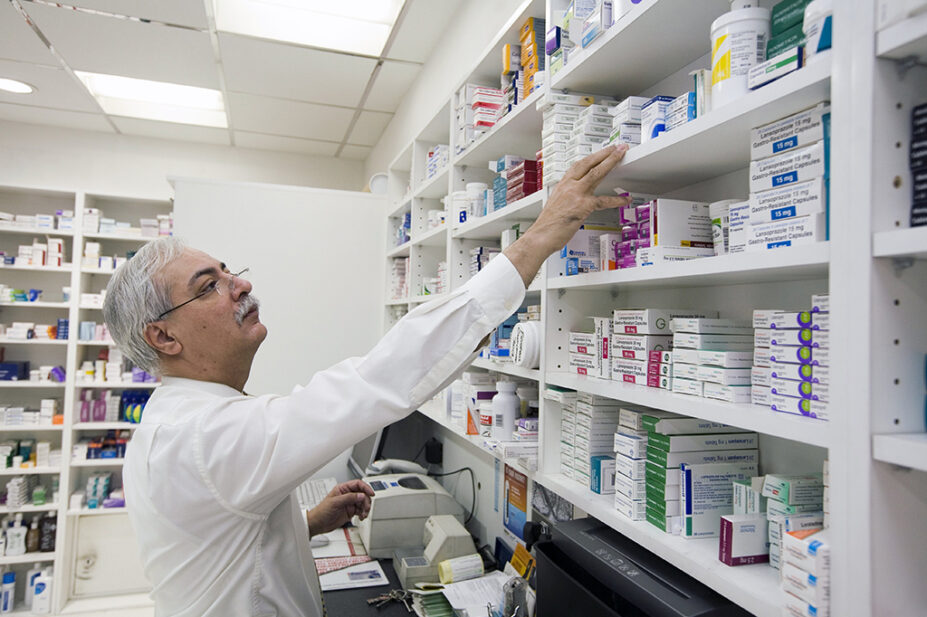 Pharmacist looking for medicine on shelf