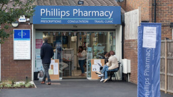 People queuing outside an independent pharmacy in Clapham, south London