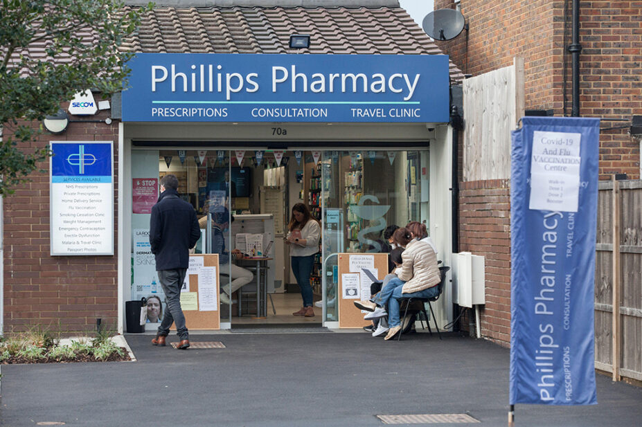 People queuing outside an independent pharmacy in Clapham, south London
