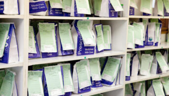 NHS Prescription medicines waiting to be collected on a chemist pharmacy shelves, Suffolk, England, UK