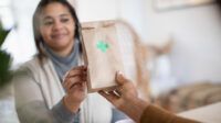 Woman collecting prescription bag from pharmacist