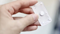 hand holding emergency contraceptive pill in blister pack