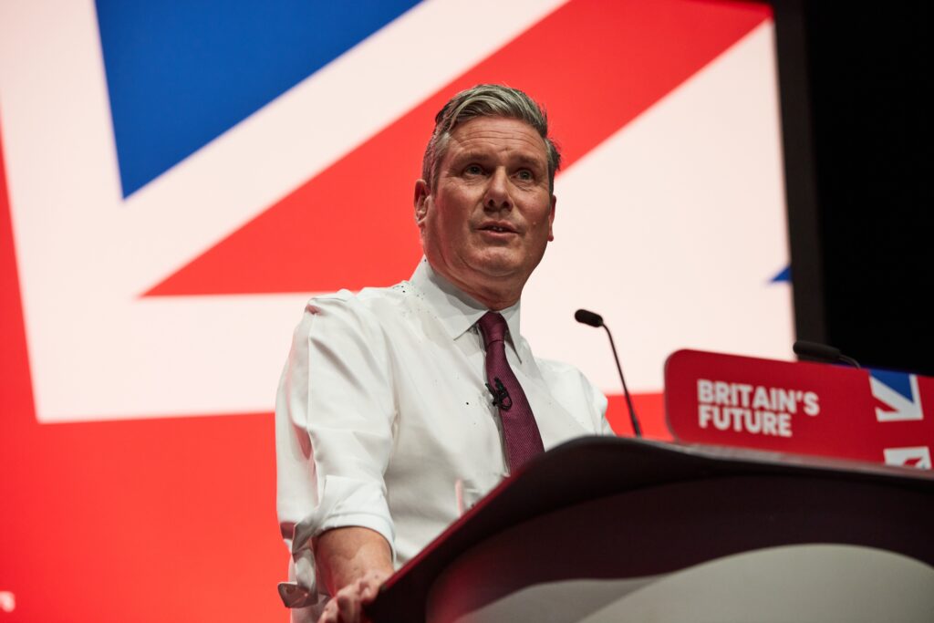 Liverpool, United Kingdom - October 10 2023: Labour Party Conference. Leader of the Opposition, Sir Keir Starmer speaking to conference, sleeves rolled up and covered in glitter from a recent protest