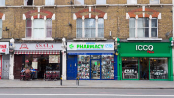 community pharmacy on street amid shops