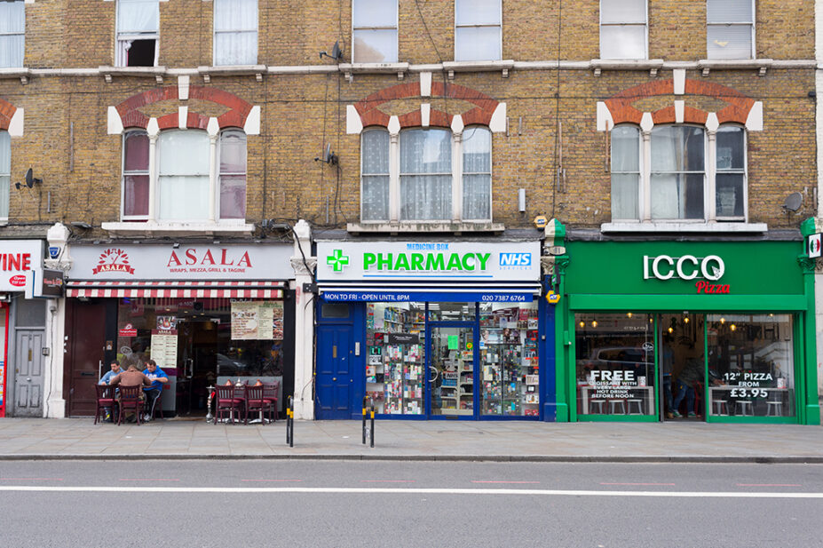 community pharmacy on street amid shops