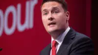 wes streeting speaking on stage