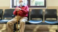 Man waiting in GP waiting room