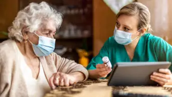 older woman discussing medication with medical practitioner