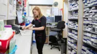 Pharmacist organising prescriptions in a dispensary