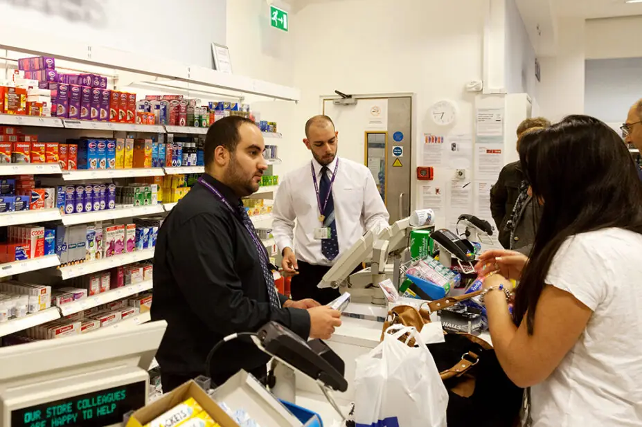 People buying medicines from UK pharmacy counter