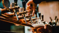 Someone pouring beer from bar tap