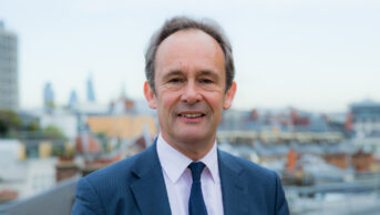 Photo of Martin Sawer, executive director of the Healthcare Distribution Association, on a cityscape background