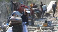 Palestinians inspect their destroyed homes, after an Israeli airstrike in the central Gaza Strip on 7 August 2024