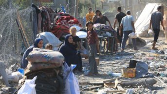 Palestinians inspect their destroyed homes, after an Israeli airstrike in the central Gaza Strip on 7 August 2024