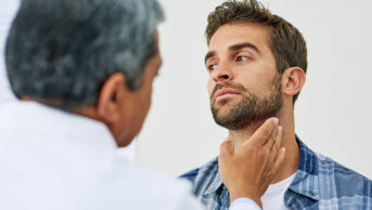 Clinician checking a person's neck